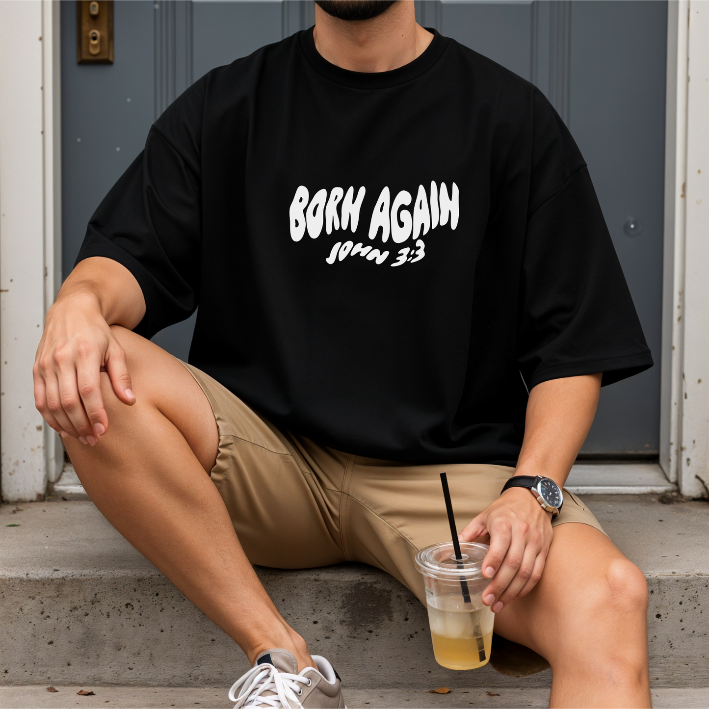 Person wearing a black t-shirt with 'Born Again' Australian christian clothing bible verse baptism shirt