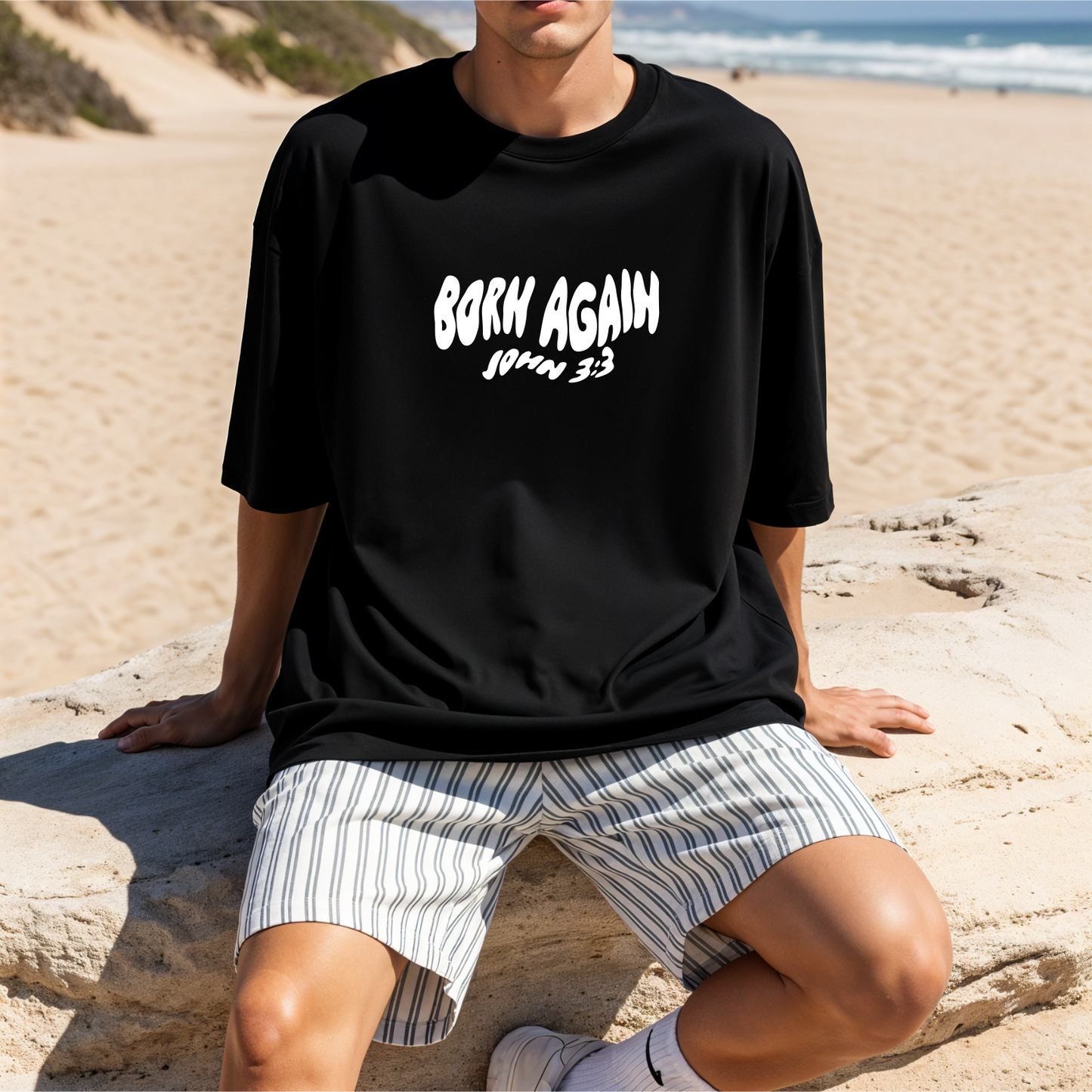 Person wearing a black t-shirt with 'Born Again' Australian christian clothing bible verse baptism shirt